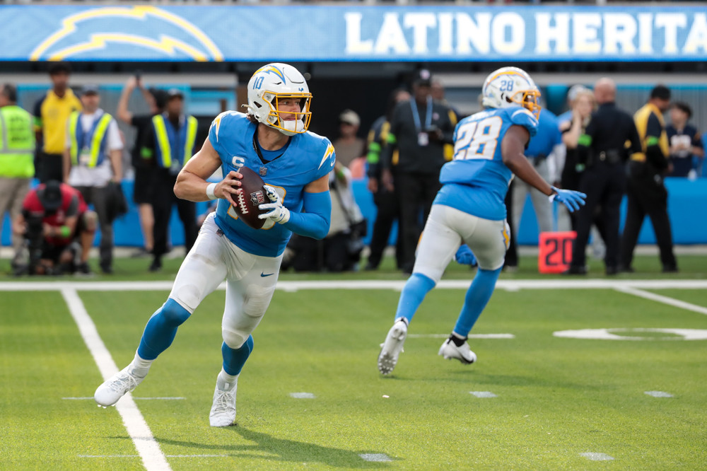 INGLEWOOD, CA - OCTOBER 1: Los Angeles Chargers quarterback Justin Herbert (10) rolls out during the NFL game between the Las Vegas Raiders and the Los Angles Chargers on October 01, 2023, at SoFi Stadium in Inglewood, CA. (Photo by Jevone Moore/Icon Sportswire)