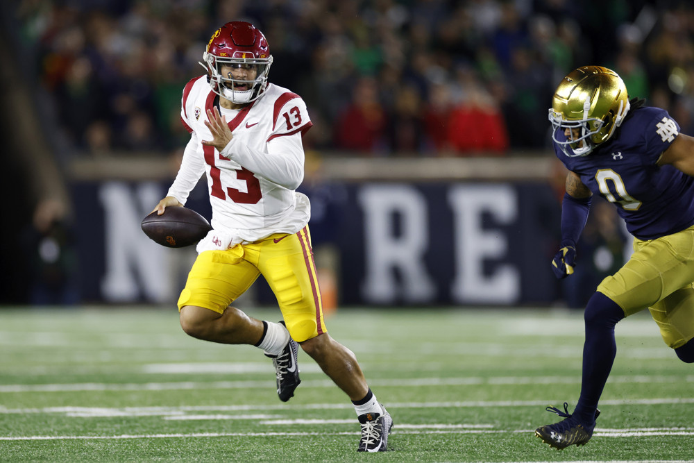 SOUTH BEND, IN - OCTOBER 14: USC Trojans quarterback Caleb Williams (13) runs for a first down on a fourth down play during a college football game against the Notre Dame Fighting Irish on October 14, 2023 at Notre Dame Stadium in South Bend, Indiana. (Photo by Joe Robbins/Icon Sportswire)