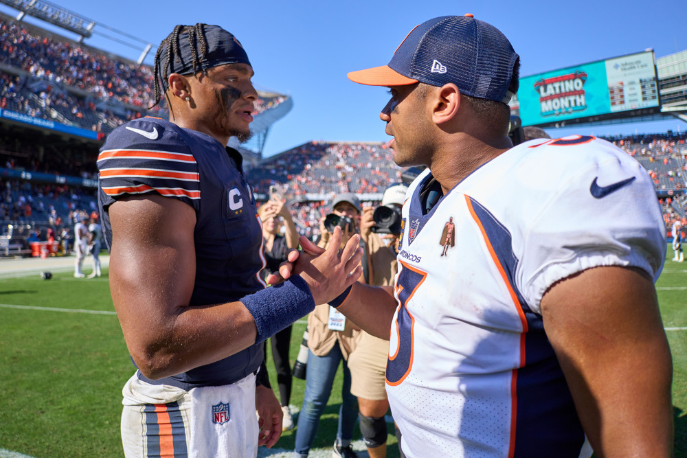 CHICAGO, IL - OCTOBER 01: Chicago Bears quarterback Justin Fields (1) and Denver Broncos quarterback Russell Wilson (3) shake hands after a game between the Chicago Bears and the Denver Broncos on October 01, 2023 at Soldier Field in Chicago, IL. (Photo by Robin Alam/Icon Sportswire)