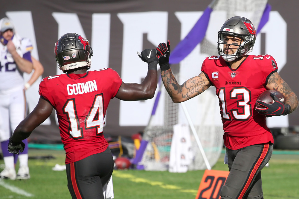 TAMPA, FL - DECEMBER 13: Chris Godwin (14) of the Bucs congratulates Mike Evans (13) on the tough catch during the regular season game between the Minnesota Vikings and the Tampa Bay Buccaneers on December 13, 2020 at Raymond James Stadium in Tampa, Florida. (Photo by Cliff Welch/Icon Sportswire)